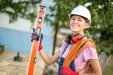 Woman builder with construction tools clipart