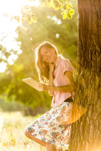 Tablet woman on a sunny day — Stock Photo, Image