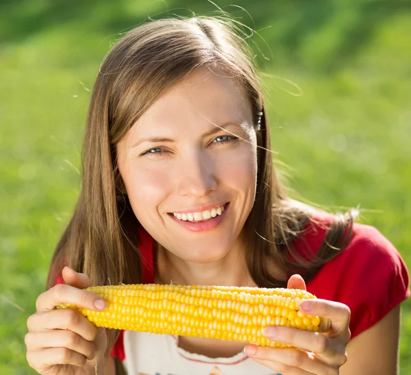 Smiling woman with corn Stock Image