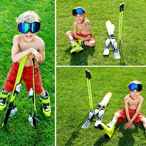 Smiling funny boy in grass with ski — Stock Photo, Image