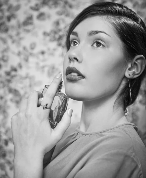 Beautiful woman smelling her perfume — Stock Photo, Image