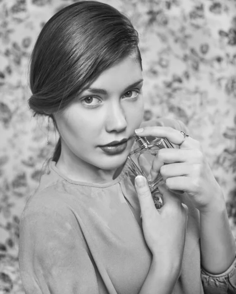 Beautiful woman smelling her perfume — Stock Photo, Image