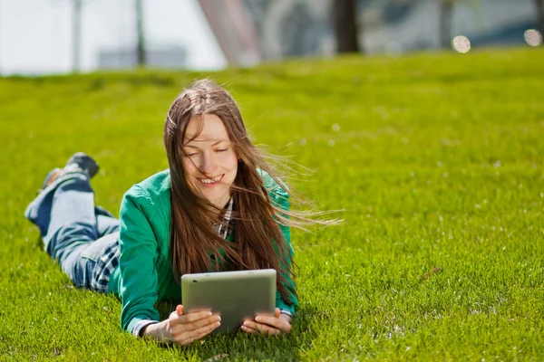 Jeune femme utilisant une tablette extérieure — Photo