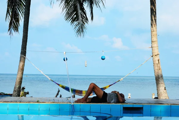 A cleaner man sleepy at the pool — Stock Photo, Image