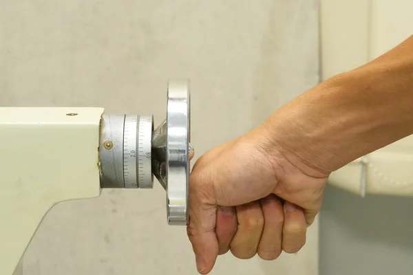 The hand try to steer on adjustable wheel on mini lathe machine — Stock Photo, Image