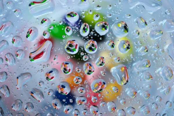 Candy in water drop — Stock Photo, Image