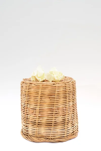 Inverted rattan basket with two garbage paper — Stock Photo, Image