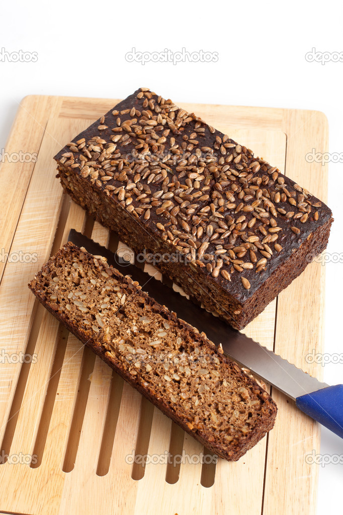 Dark rye bread whith knife on a board