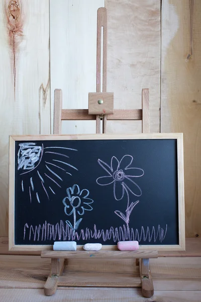 Children's drawing with easel on chalk board — Stock Photo, Image