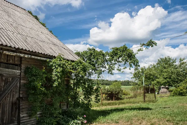 Old wooden bar with over the blue sky with light clouds — Stock Photo, Image