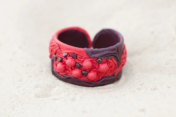 Handmade bracelet with leather on sand — Stock Photo, Image