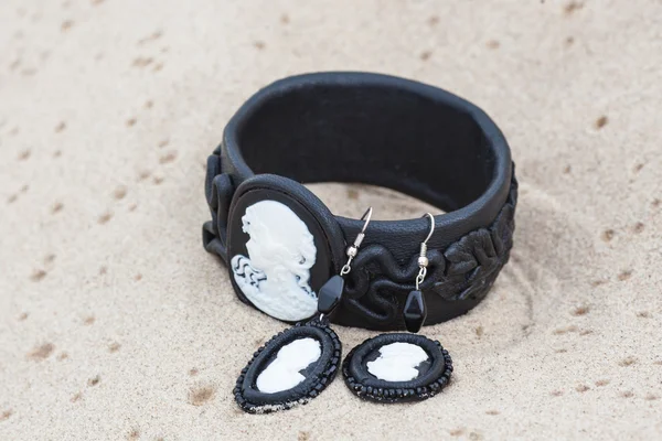 Handmade bracelet with leather on sand — Stock Photo, Image