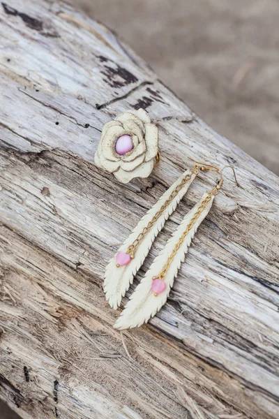 Handmade leather earrings on sand — Stock Photo, Image