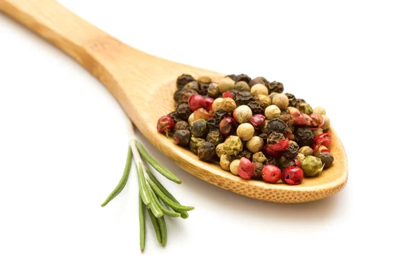 Mixed pepper in spoon on white background — Stock Photo, Image