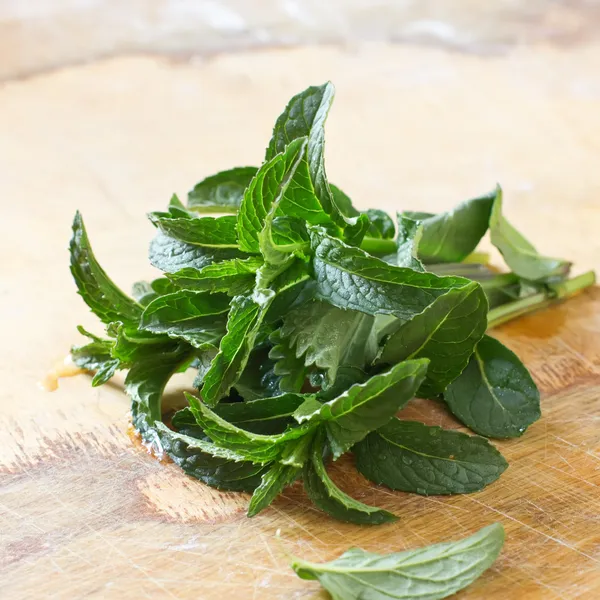 Fresh organic mint on wooden table — Stock Photo, Image