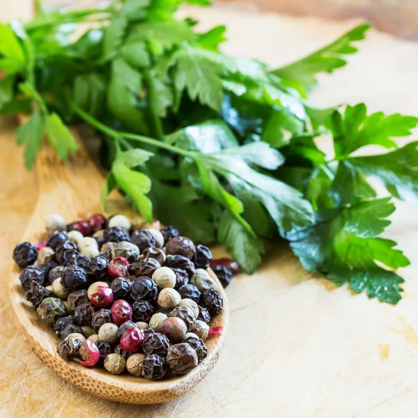 Mixed pepper on wooden background — Stock Photo, Image