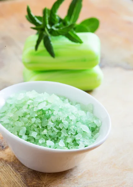 Sea salt in bowl on wooden background — Stock Photo, Image