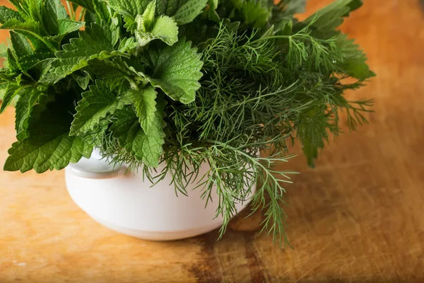 Fresh organic herbs on wooden table — Stock Photo, Image