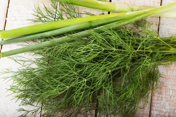 Fresh dill and grteen onion on wooden board — Stock Photo, Image