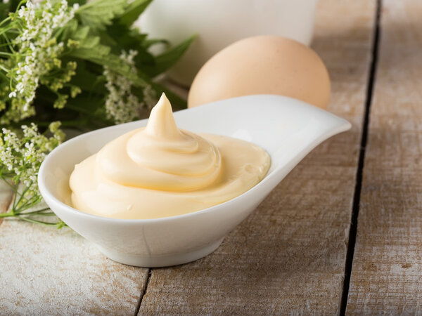 Mayonnaise in bowl on table