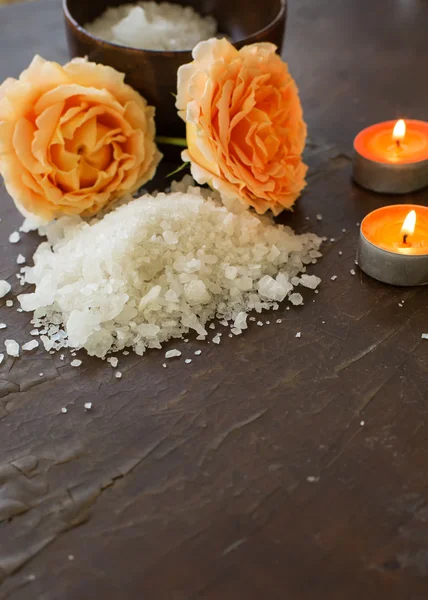 Sea salt with rose and candles on wooden background — Stock Photo, Image