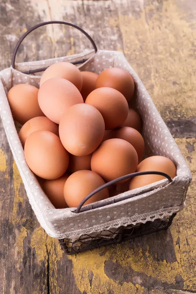 Eggs in bucket on wooden background — Stock Photo, Image