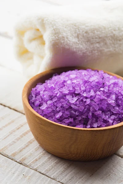 Sea salt in bowl on wooden background — Stock Photo, Image