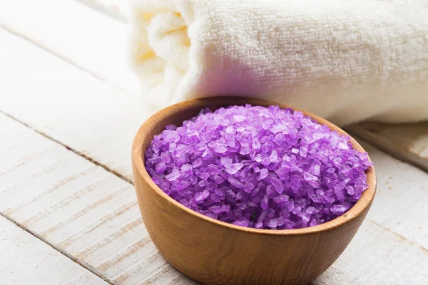 Sea salt in bowl on wooden background — Stock Photo, Image