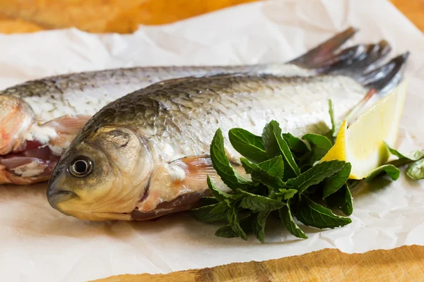 Peixe cru fresco na mesa de madeira — Fotografia de Stock