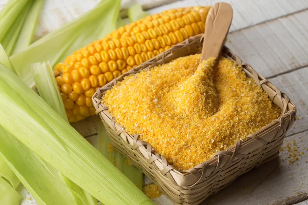 Corn meal on wooden background — Stock Photo, Image