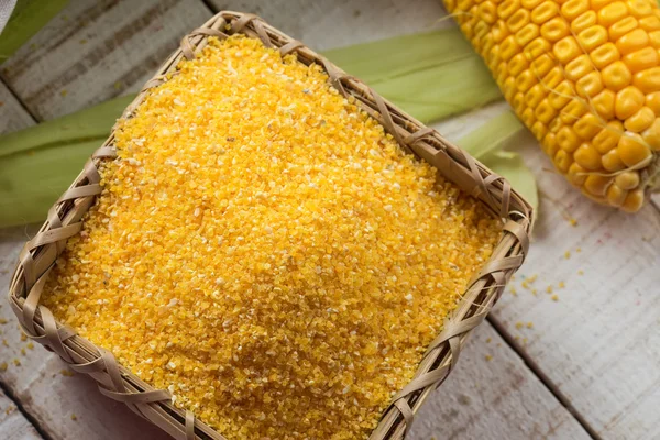 Corn meal on wooden background — Stock Photo, Image