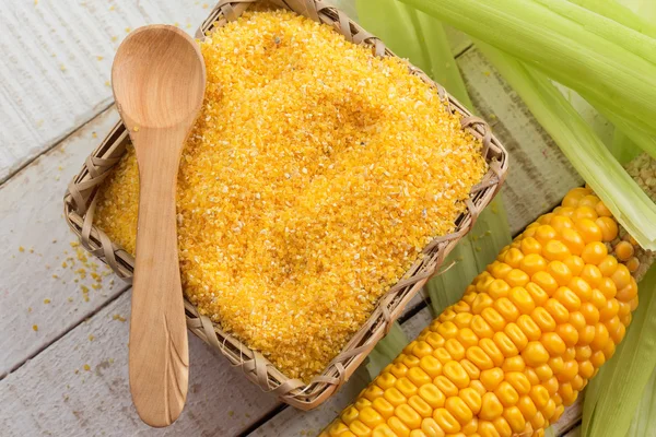 Corn meal on wooden background — Stock Photo, Image
