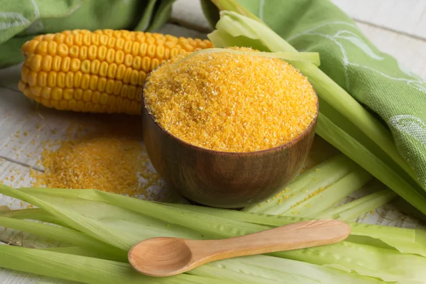 Corn meal on wooden background — Stock Photo, Image