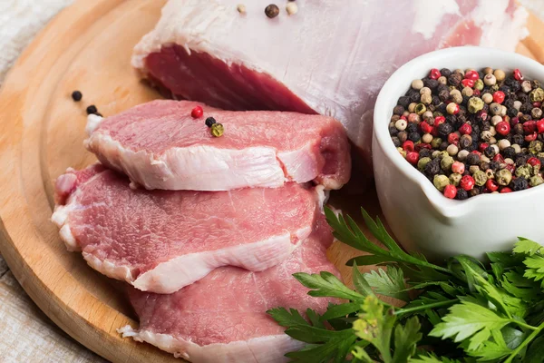 Carne crua fresca em fundo de madeira com pimenta — Fotografia de Stock