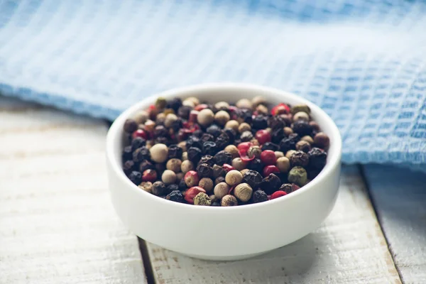 Mixed pepper on wooden background — Stock Photo, Image