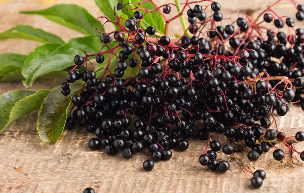Elderberry on wooden table — Stock Photo, Image