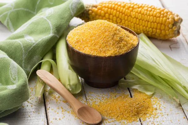 Corn meal on wooden background — Stock Photo, Image