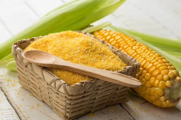 Corn meal on wooden background — Stock Photo, Image