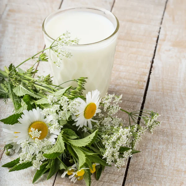 Milk in glass on wooden table — Stock Photo, Image