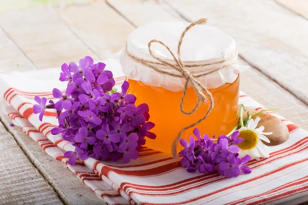 Fresh honey with flowers — Stock Photo, Image