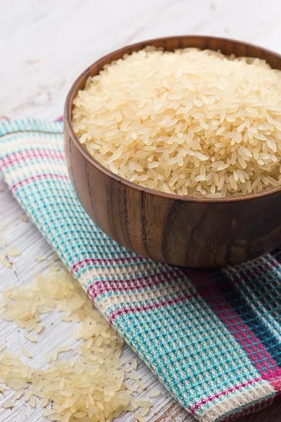 Raw rice in wooden bowl — Stock Photo, Image