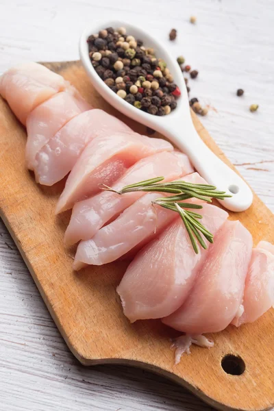 Fresh chicken on wooden table — Stock Photo, Image
