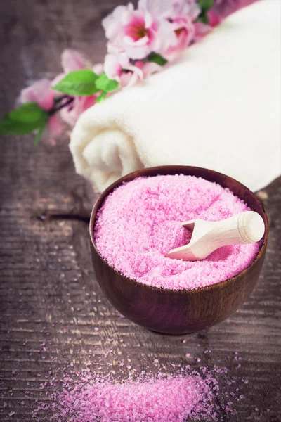 Sea salt in bowl on wooden background — Stock Photo, Image