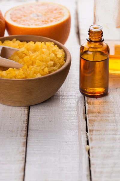 Sea salt in bowl, aroma oil and orange — Stock Photo, Image