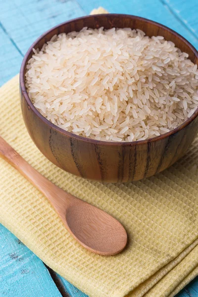 Raw rice in wooden bowl — Stock Photo, Image