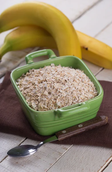 Oat flakes in bowl with banana