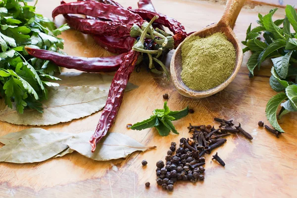 Different  seasoning on wooden table — Stock Photo, Image