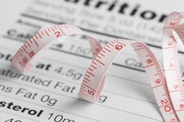 Measure tape and nutrition facts — Stock Photo, Image