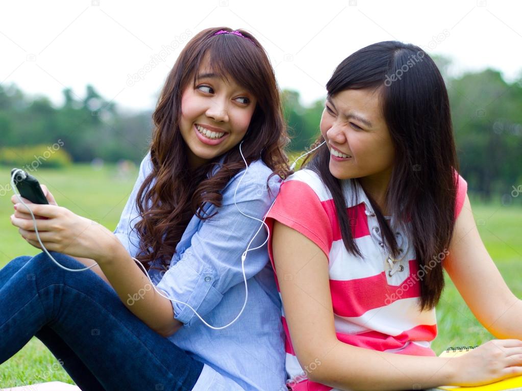 Girls listening to music together.