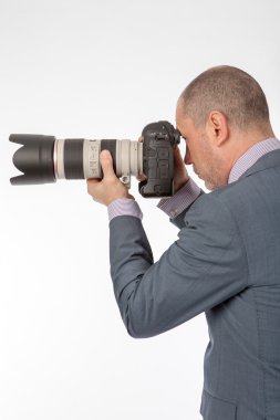 Close-up of photographer with camera. clipart